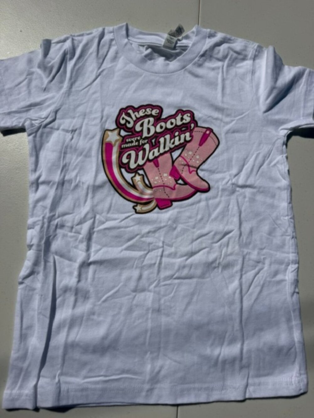 Kids graphic t-shirt featuring a western-style "Boots Were Made for Walkin"